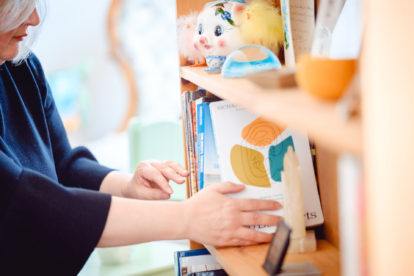 janet mcdonald placing a book on a shelf