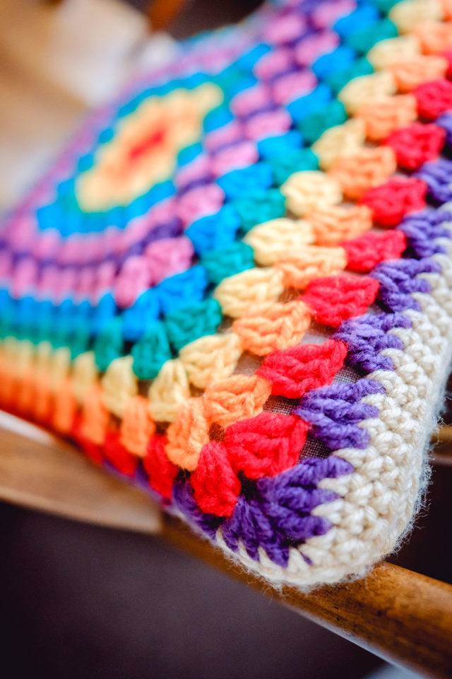 rainbow coloured knit pillow